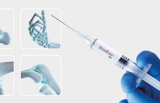 A prefilled syringe against a light background with laboratory photographs