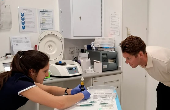 Two specialists working with laboratory equipment